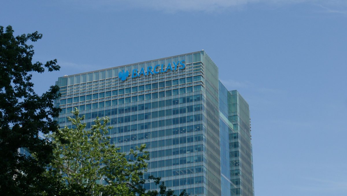 A glass office tower with the Barclays name on its roof